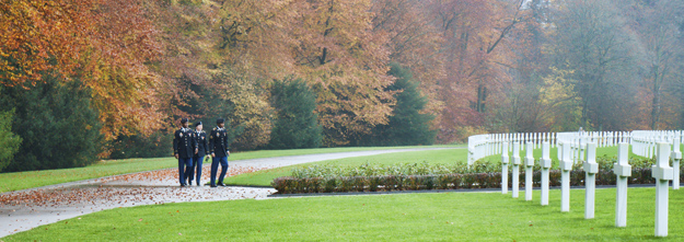 Photograph of Luxembourg American Cemetary, Veterans Day 2014, three soldiers rounding the corner, by Peter Free.